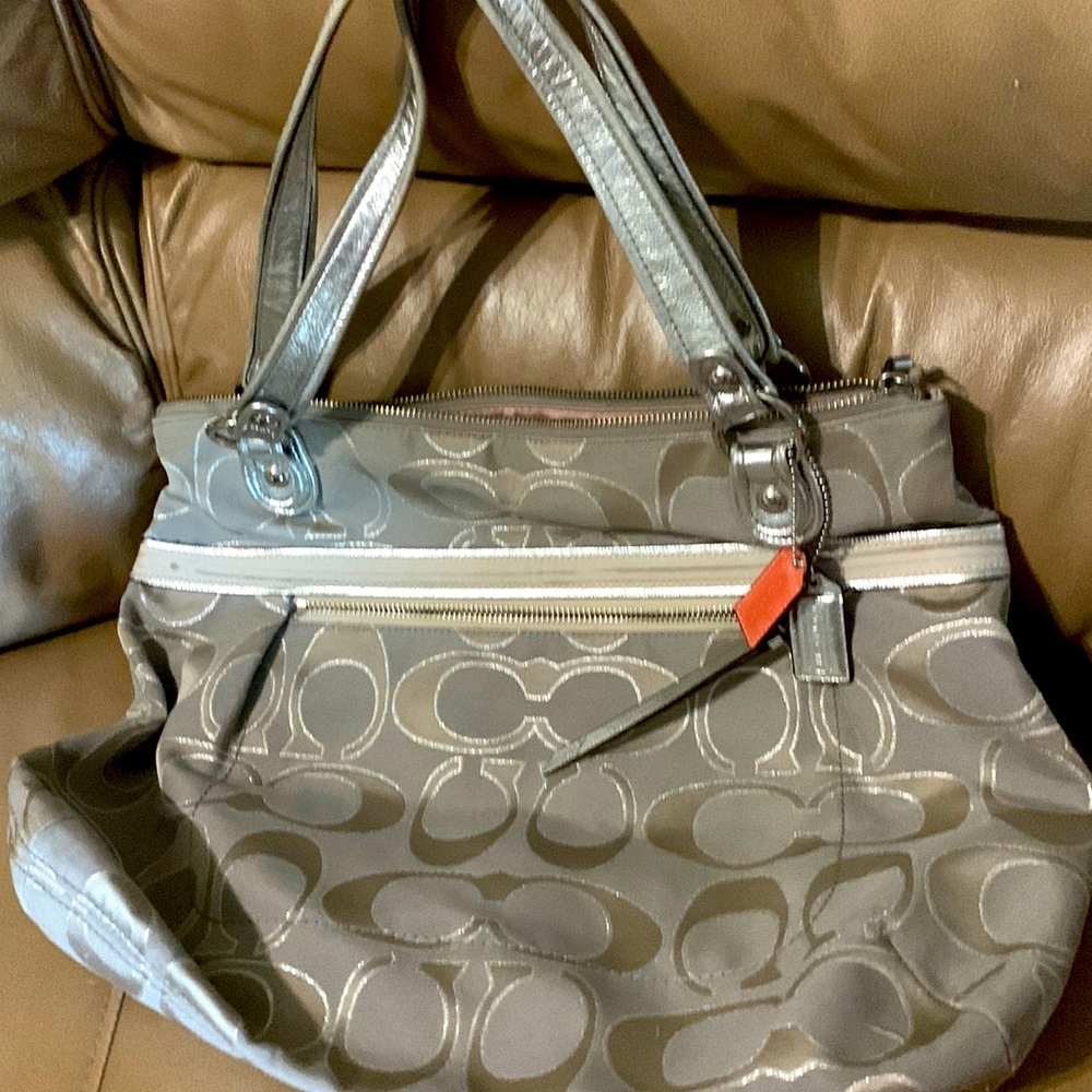 Coach bag. great shape silver. pink silk inside